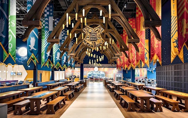 Great Hall dining area at Harry Potter Studios with house banners and floating candles.