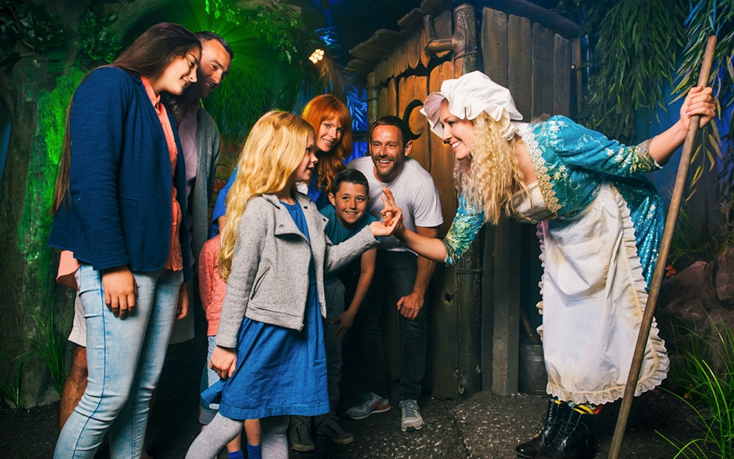 Group interacting with a costumed character at Shrek’s Adventure! London.