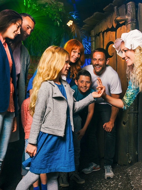 Group interacting with a costumed character at Shrek’s Adventure! London.