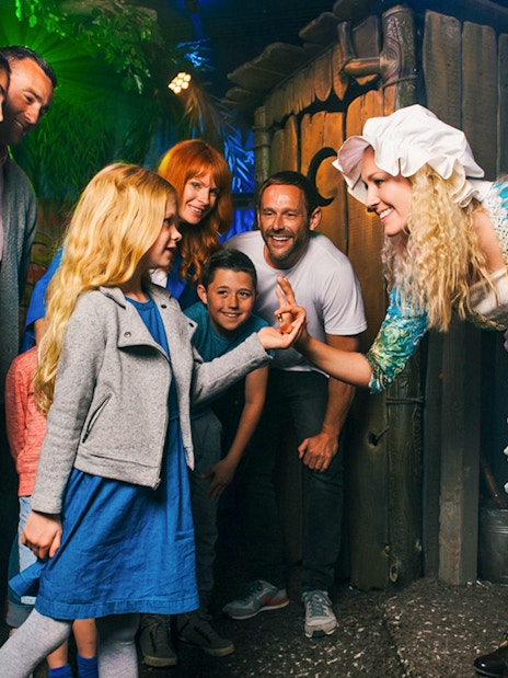 Group interacting with a costumed character at Shrek’s Adventure! London.