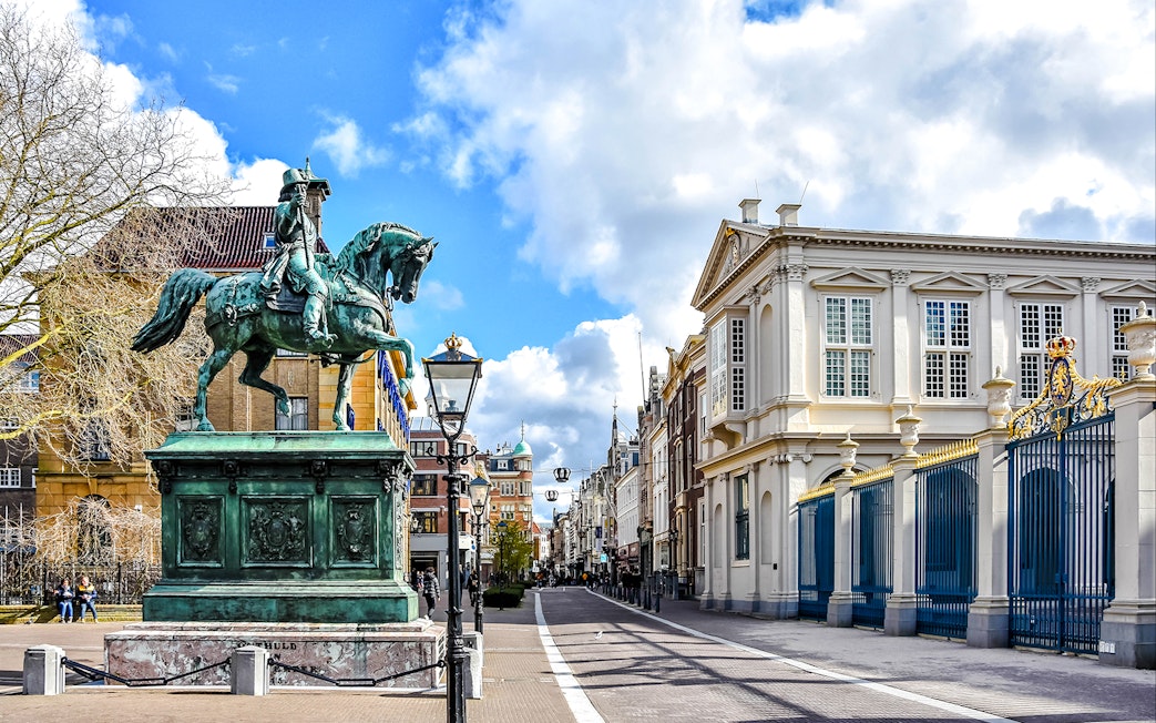 Equestrian statue and historic buildings on Noordeinde street, City Center, the Netherlands.