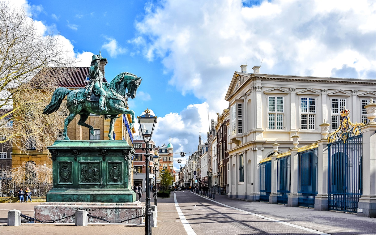 Equestrian statue and historic buildings on Noordeinde street, City Center, the Netherlands.