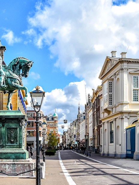 Equestrian statue and historic buildings on Noordeinde street, City Center, the Netherlands.