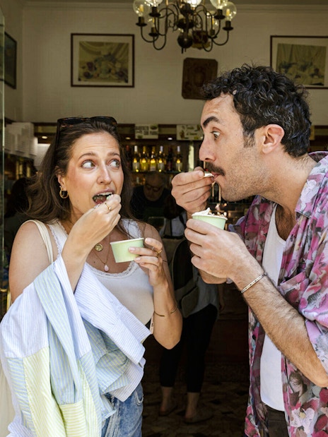 Two people enjoying ice cream during a Food & Market Tour.