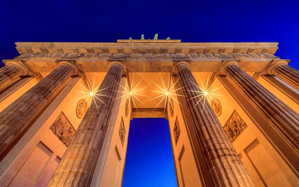 Brandenburg Gate illuminated at night, Berlin, part of QueerCityPass Berlin ABC tour.