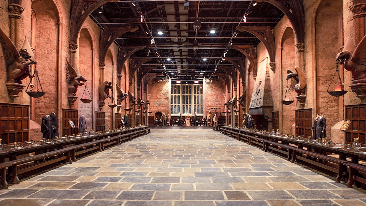 Great Hall set with long tables and costumes during Harry Potter London tour.