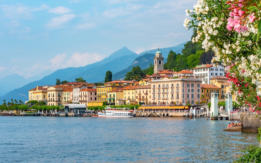 Lakeside view of Bellagio, Italy with colorful buildings and mountains in the background.