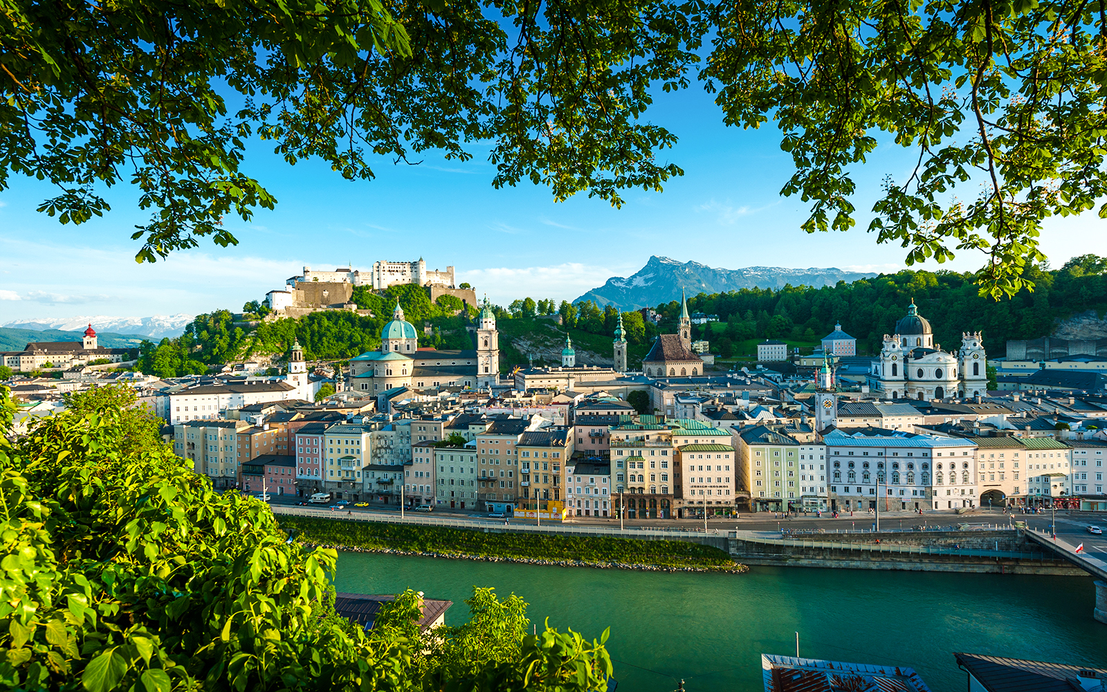 Salzburg cityscape with Hohensalzburg Fortress and Salzach River, view from a hop-on hop-off tour.