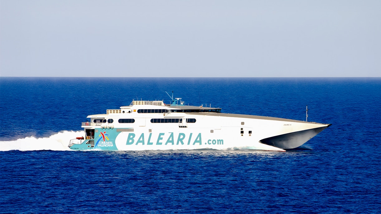 High-speed catamaran ferry sailing from Miami to Bimini, Bahamas, with passengers on deck.