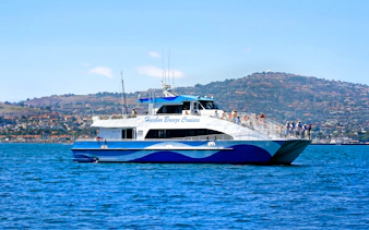 Whale watching boat on Los Angeles tour with passengers viewing ocean.