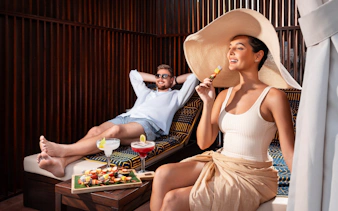 Couple enjoying barbecue and drinks at Grand Hyatt waterpark, Dubai.