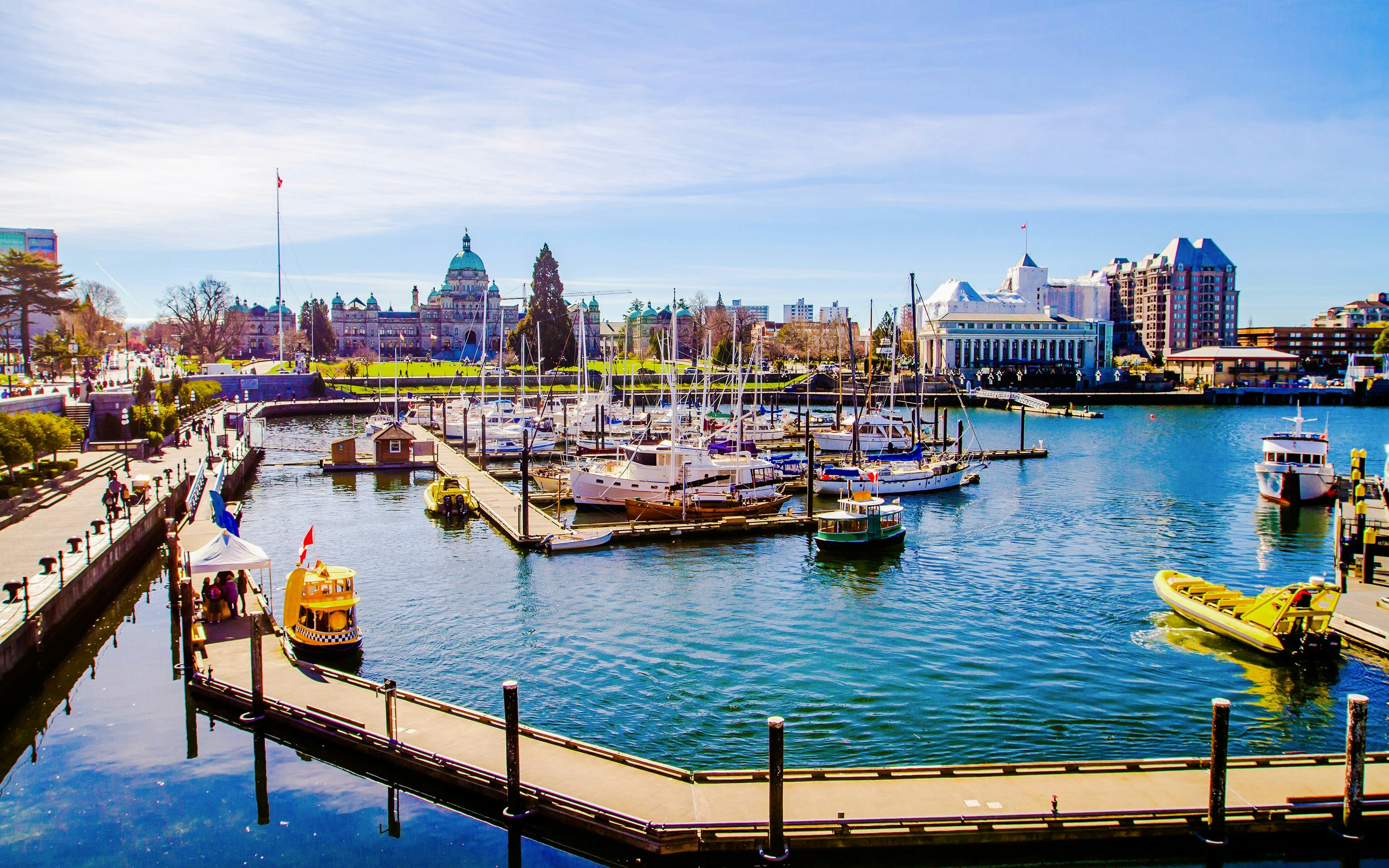Victoria Inner Harbour with boats docked and the Parliament Buildings in the background.
