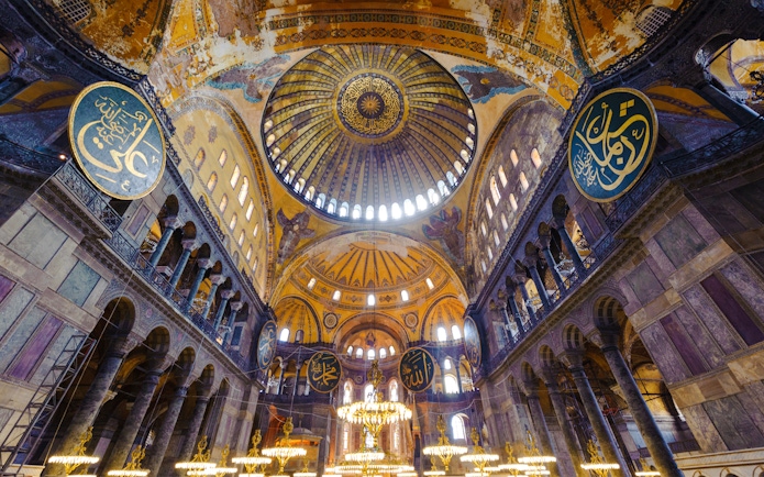 Hagia Sophia interior with ornate dome and Islamic calligraphy, Istanbul, Turkey.