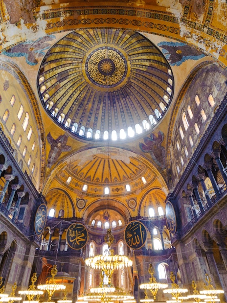 Hagia Sophia interior with ornate dome and Islamic calligraphy, Istanbul, Turkey.