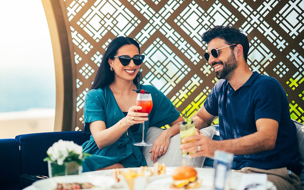 Couple enjoying drinks at Burj Al Arab, Dubai.