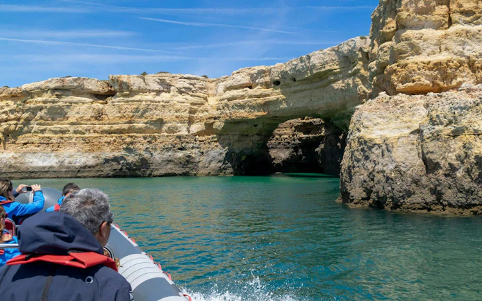 Boat approaching Benagil Cave on a tour from Portimão, Algarve coast.