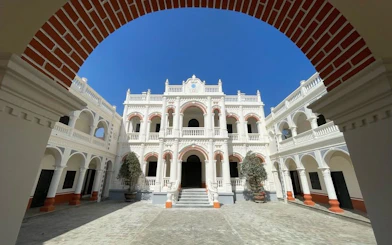 Courtyard of a historic building with arches in Bac Ha Market area, Vietnam.