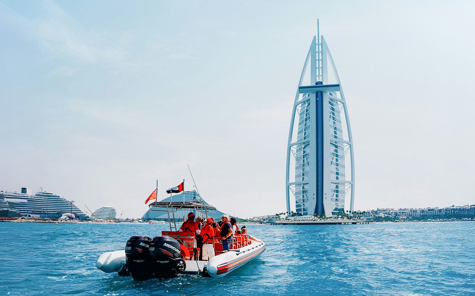 Speedboat cruising past Dubai Marina with views of Atlantis, Palm Jumeirah, and Burj Al Arab.