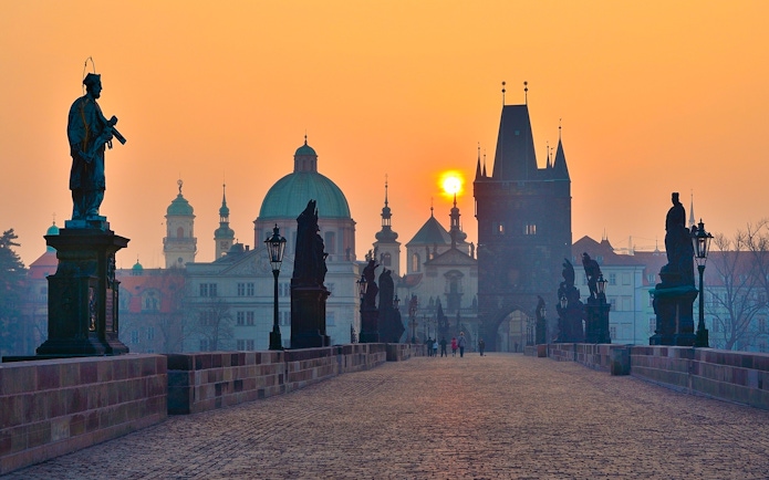 Charles Bridge at sunrise with statues, Prague.