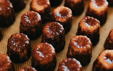 Canelés arranged on a tray for tasting on Bordeaux River Cruise.
