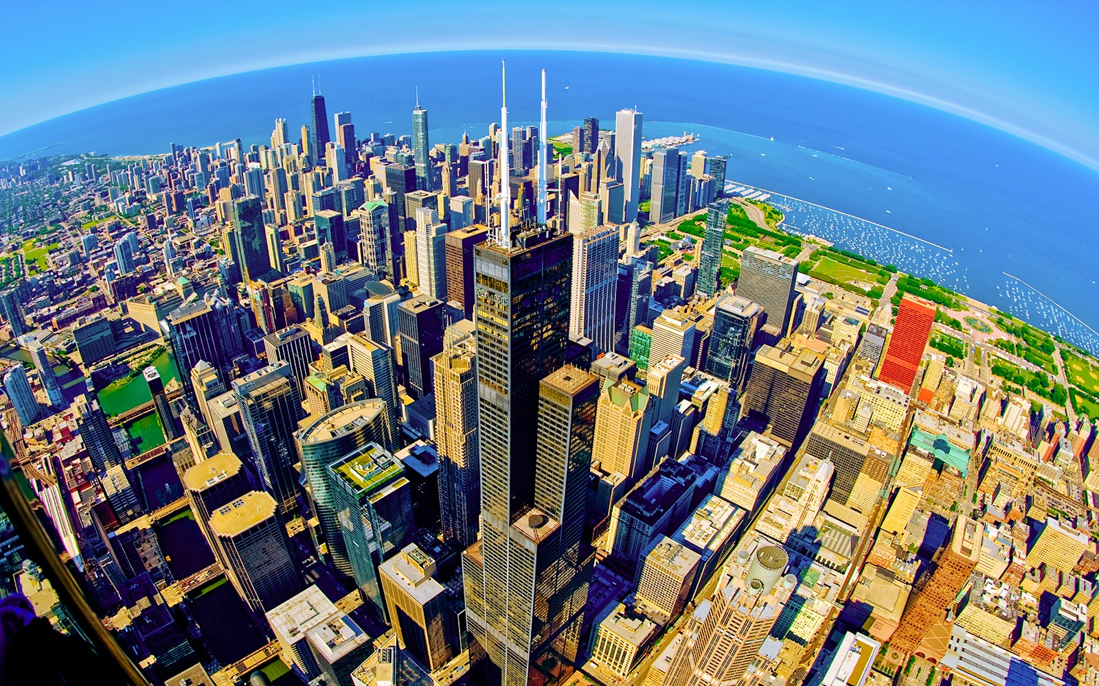 View from Skydeck at Willis Tower, Chicago, overlooking city skyline and Lake Michigan.