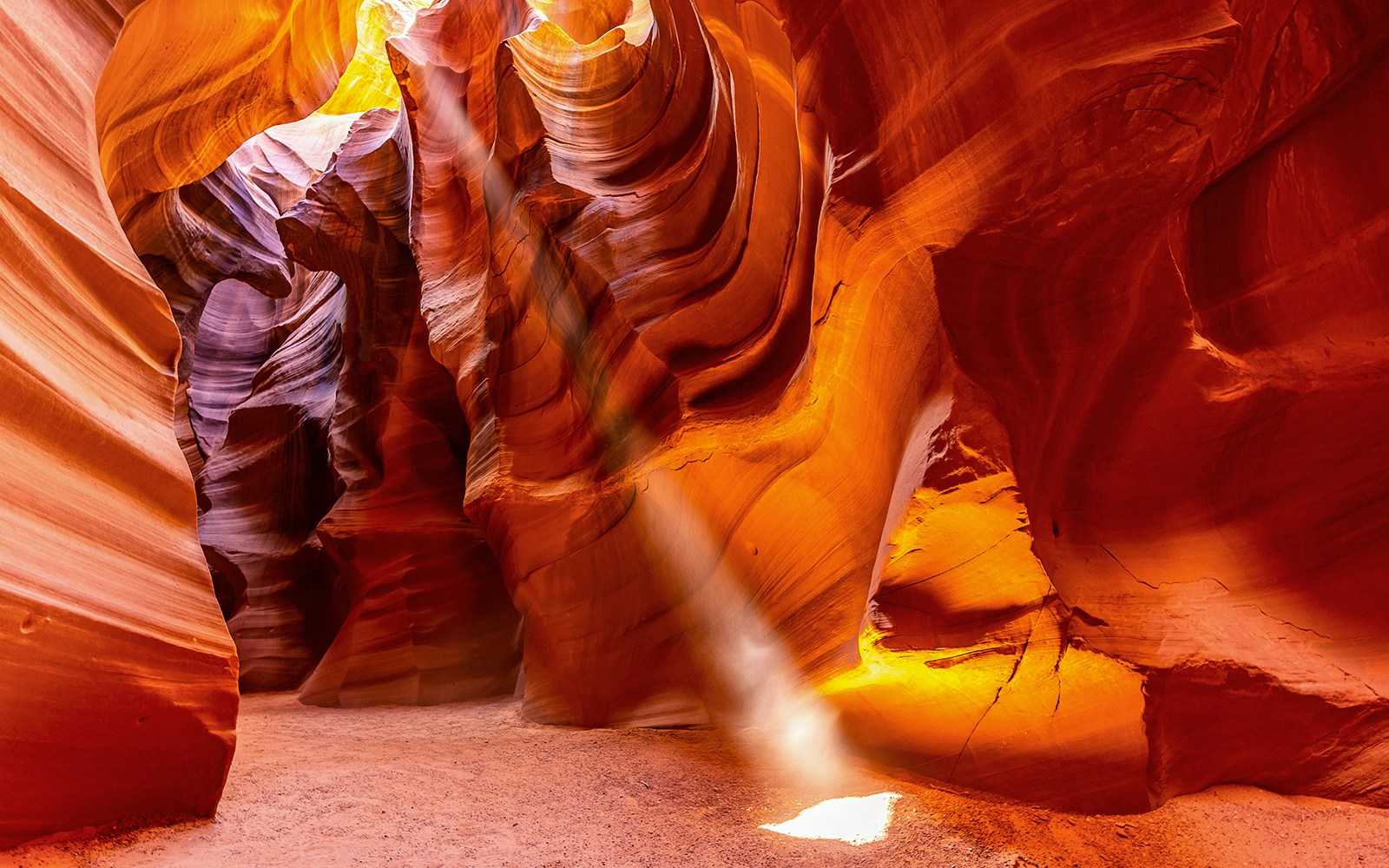 Upper Antelope Canyon sandstone formations with light beams during tour in Arizona.