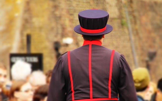 Beefeater in traditional uniform at the Tower of London, England.