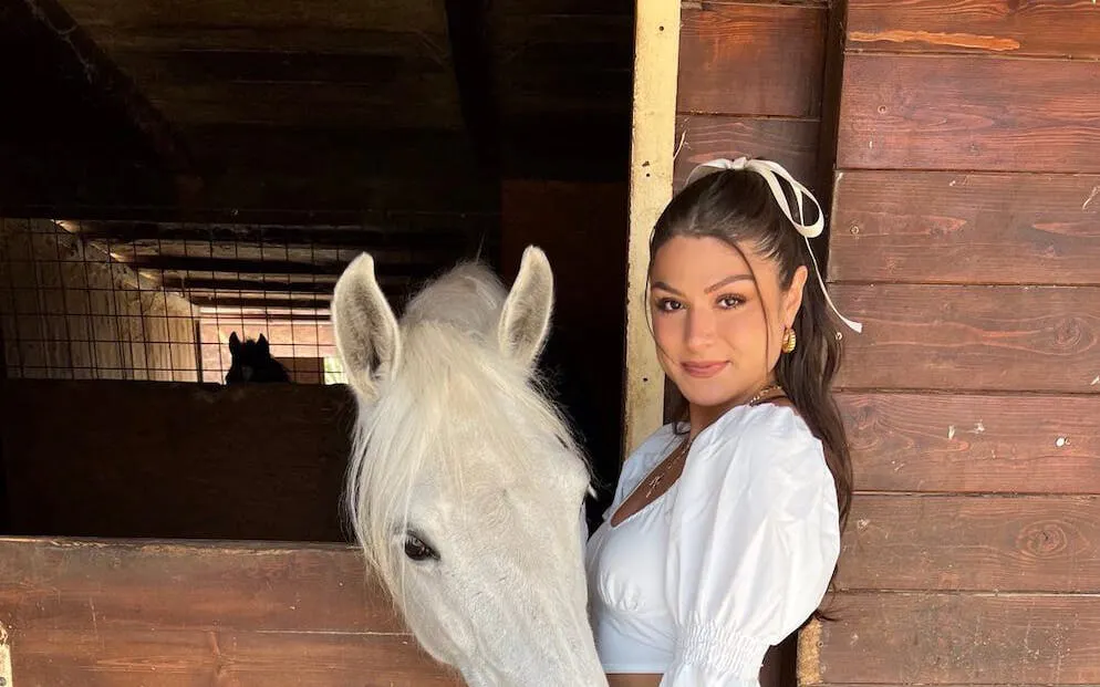 Horse and rider in a stable, Tuscany countryside tour with views of San Gimignano.