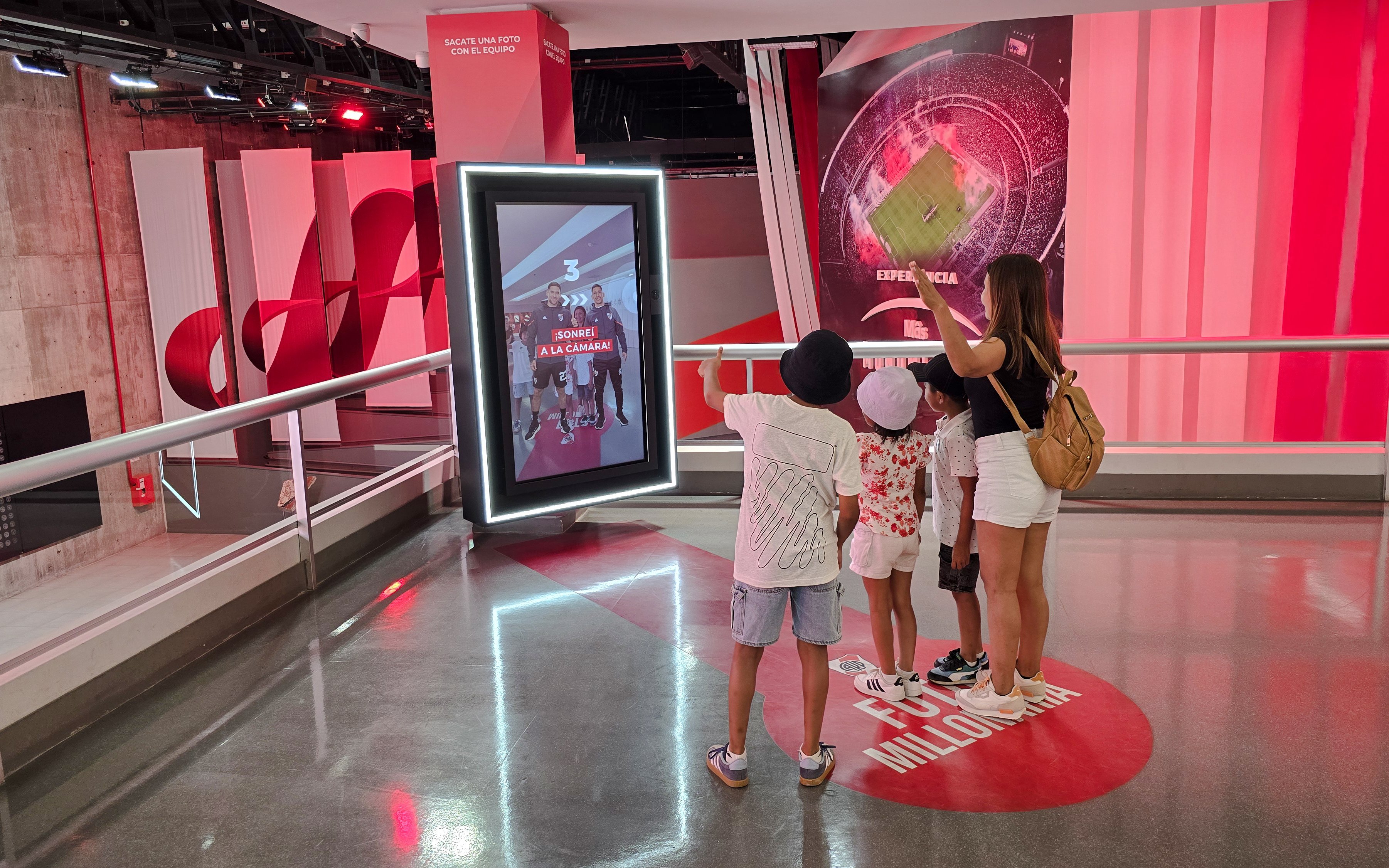 Visitors interacting with a digital display at Museo River in Mâs Monumental stadium, Buenos Aires.