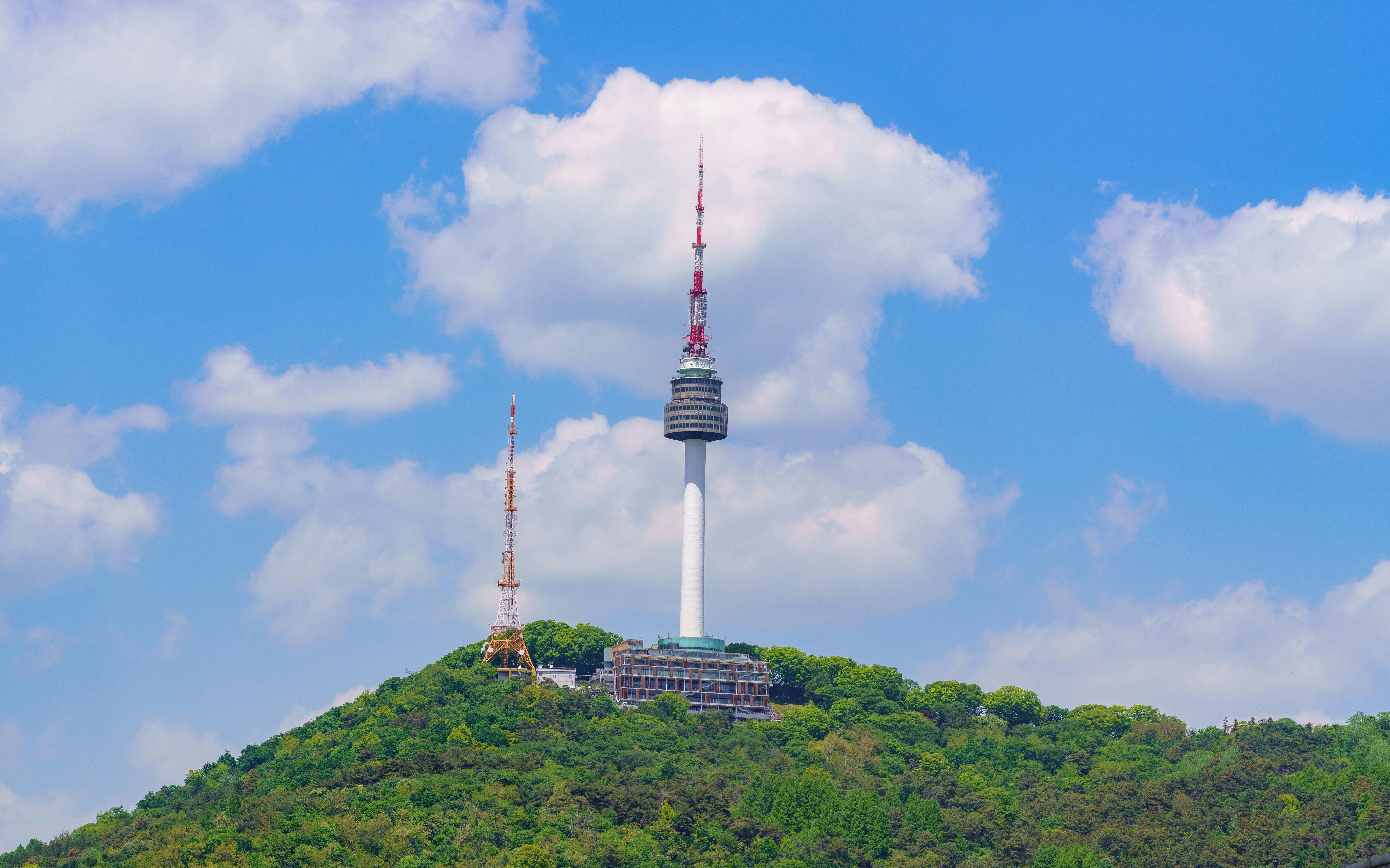 N Seoul Tower on Haebangchon Hillside under a blue sky.