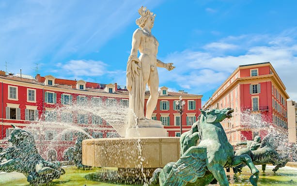 Fountain of the Sun in Nice's Old Town with statue and water features.