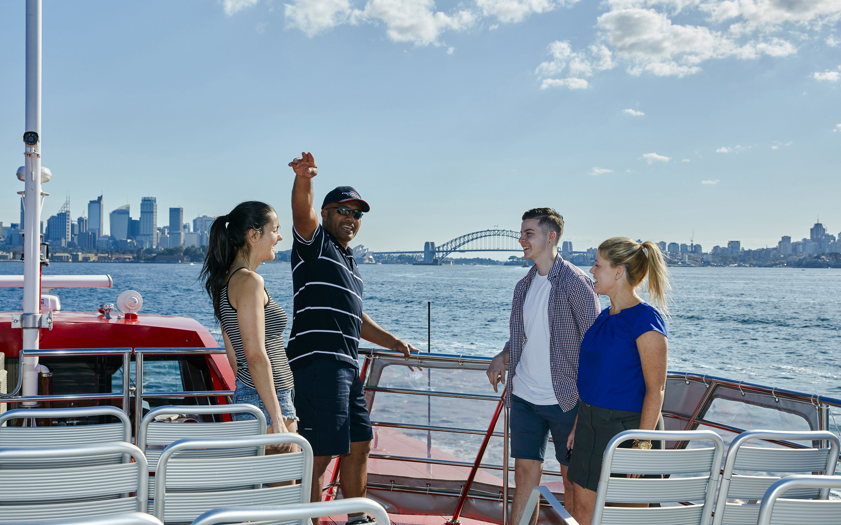 Cruise guests enjoying Sydney Harbour views with Sydney Harbour Bridge in the background.