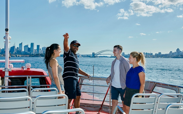 Cruise guests enjoying Sydney Harbour views with Sydney Harbour Bridge in the background.