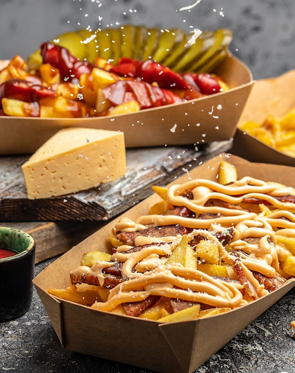 Fries with cheese and sauce in Amsterdam culinary tour.