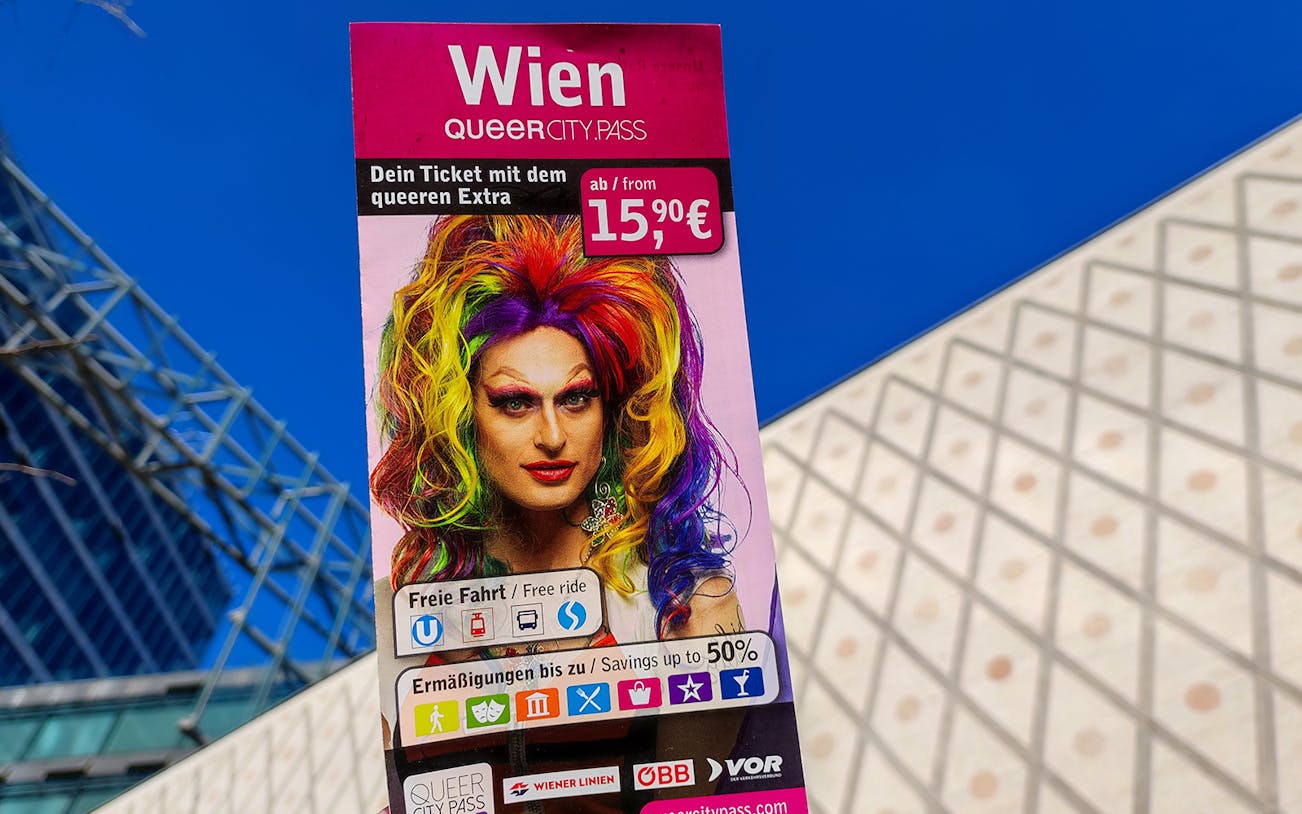 QueerCityPass Vienna poster with colorful drag performer, offering discounts and free rides.
