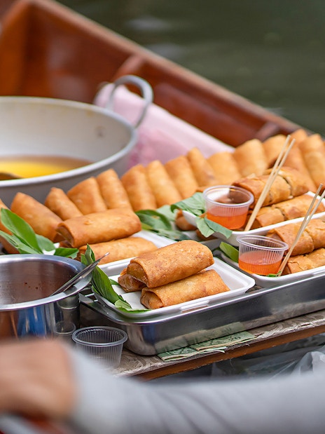 Spring rolls on a boat at Damnoen Saduak Floating Market, Bangkok tour.