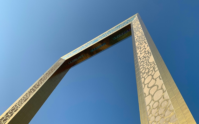 Close-up view of the Dubai Frame against a clear blue sky.