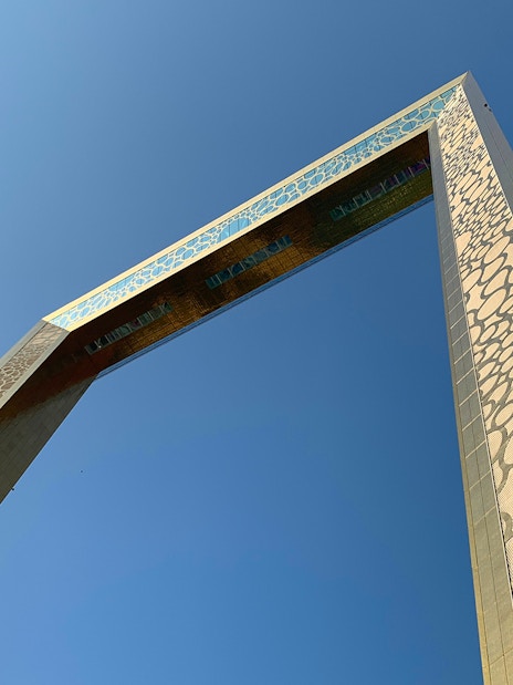 Close-up view of the Dubai Frame against a clear blue sky.