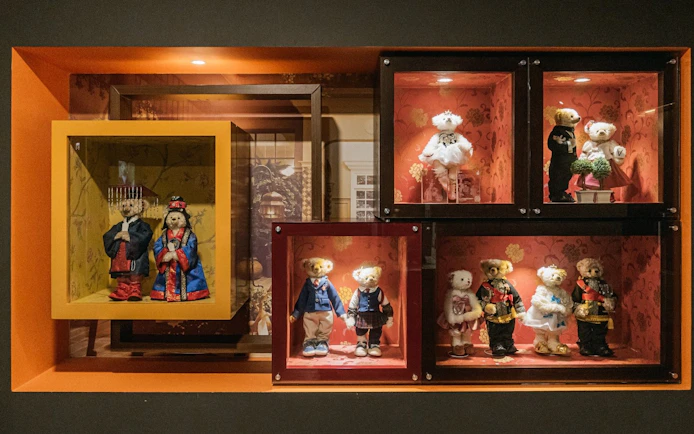 Teddy bears in traditional and formal attire displayed at Teddy Bear Museum.