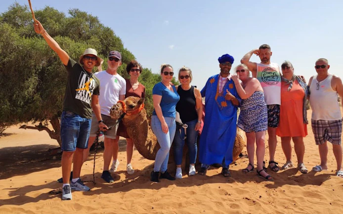 Group with camel on Agadir Sahara Desert tour.