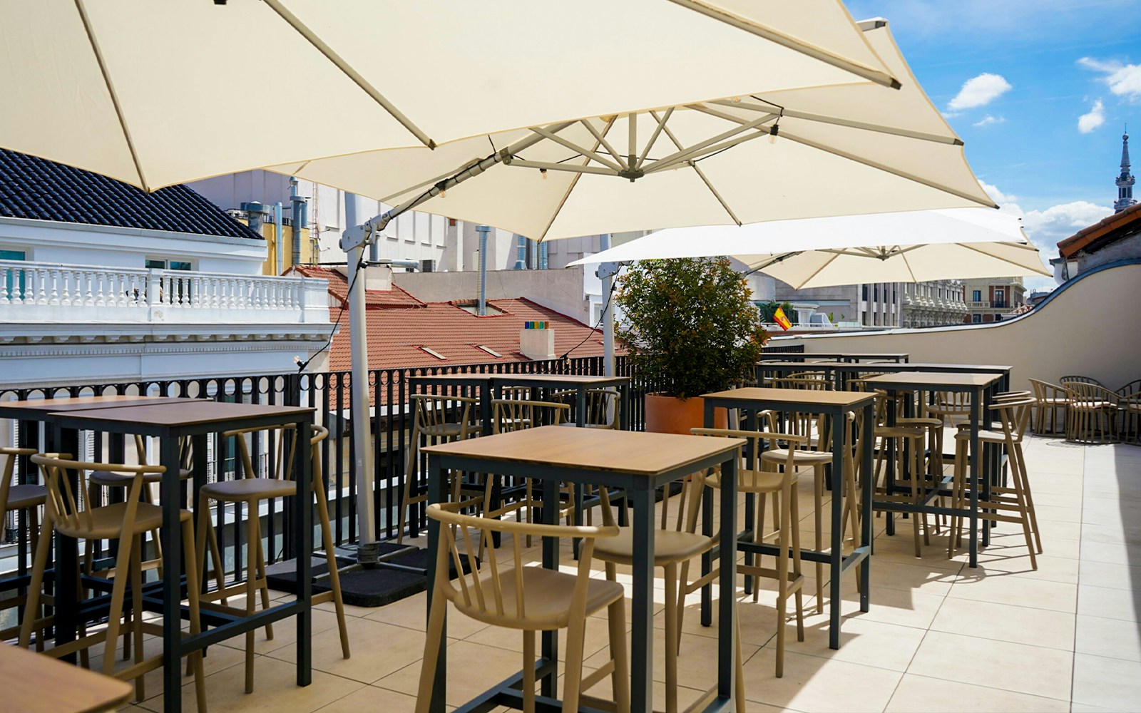 Rooftop terrace dining area with city view in Madrid's Legends Collection.