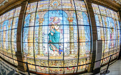Stained glass windows depicting classical figures inside Chapultepec Castle, Mexico City.