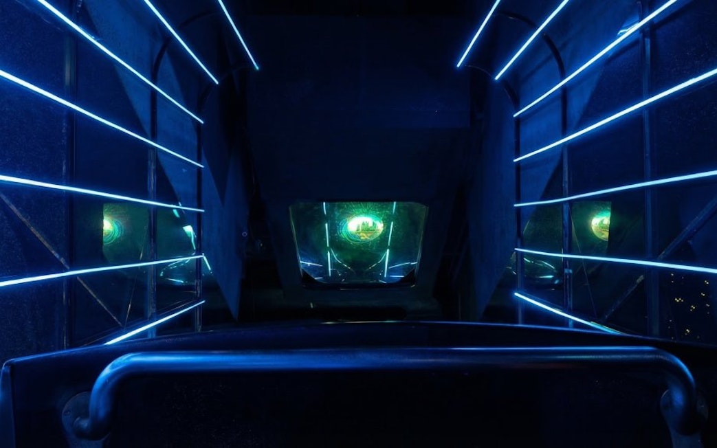 Exit ride capsule interior at Petrosains with illuminated blue lines.
