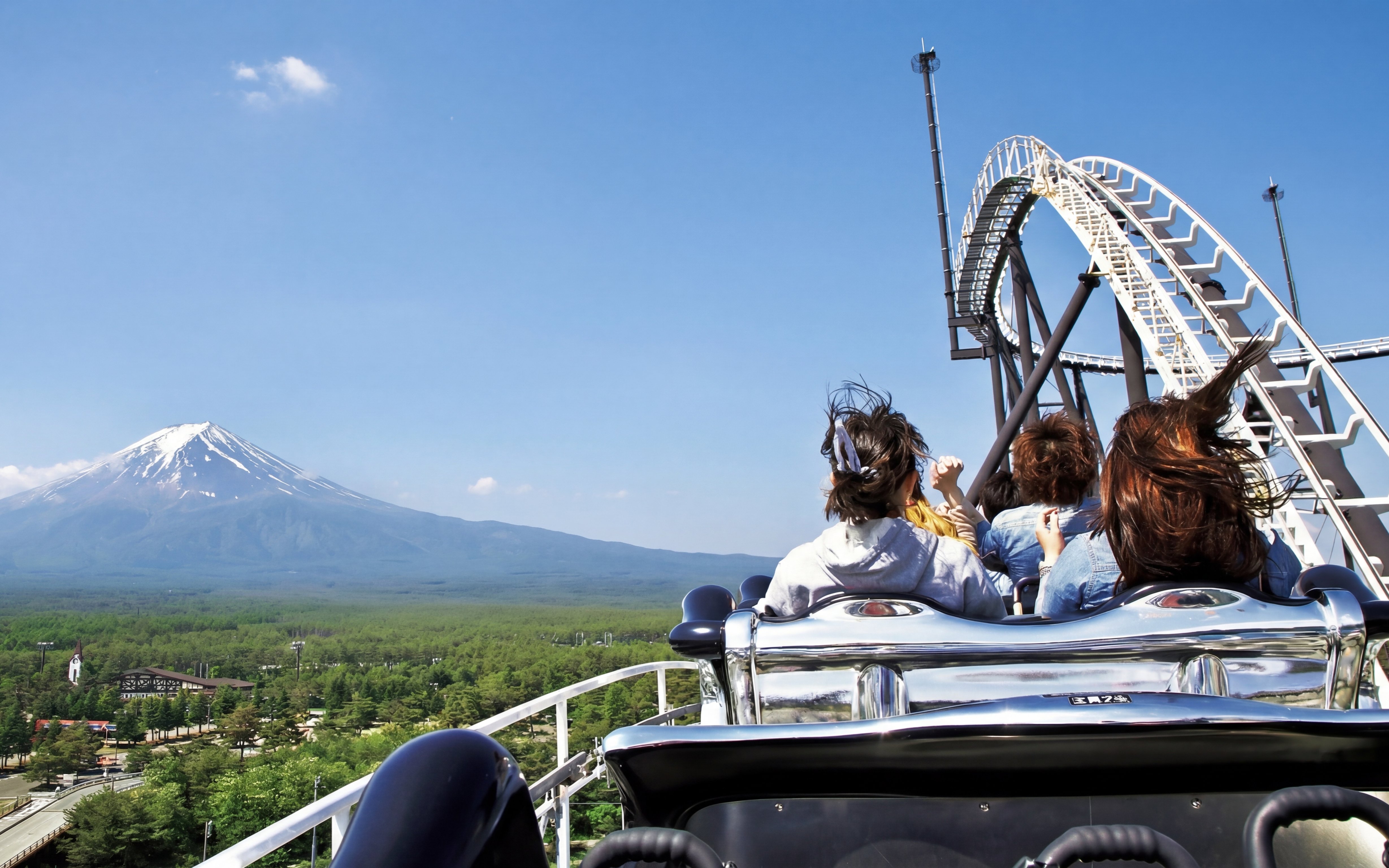 Roller coaster at Fuji-Q Highland with Mount Fuji in the background.