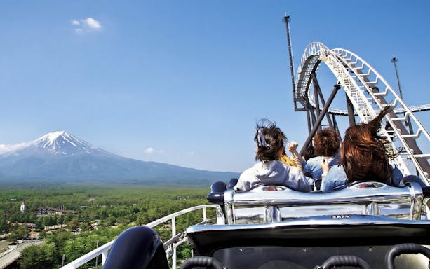 Roller coaster at Fuji-Q Highland with Mount Fuji in the background.