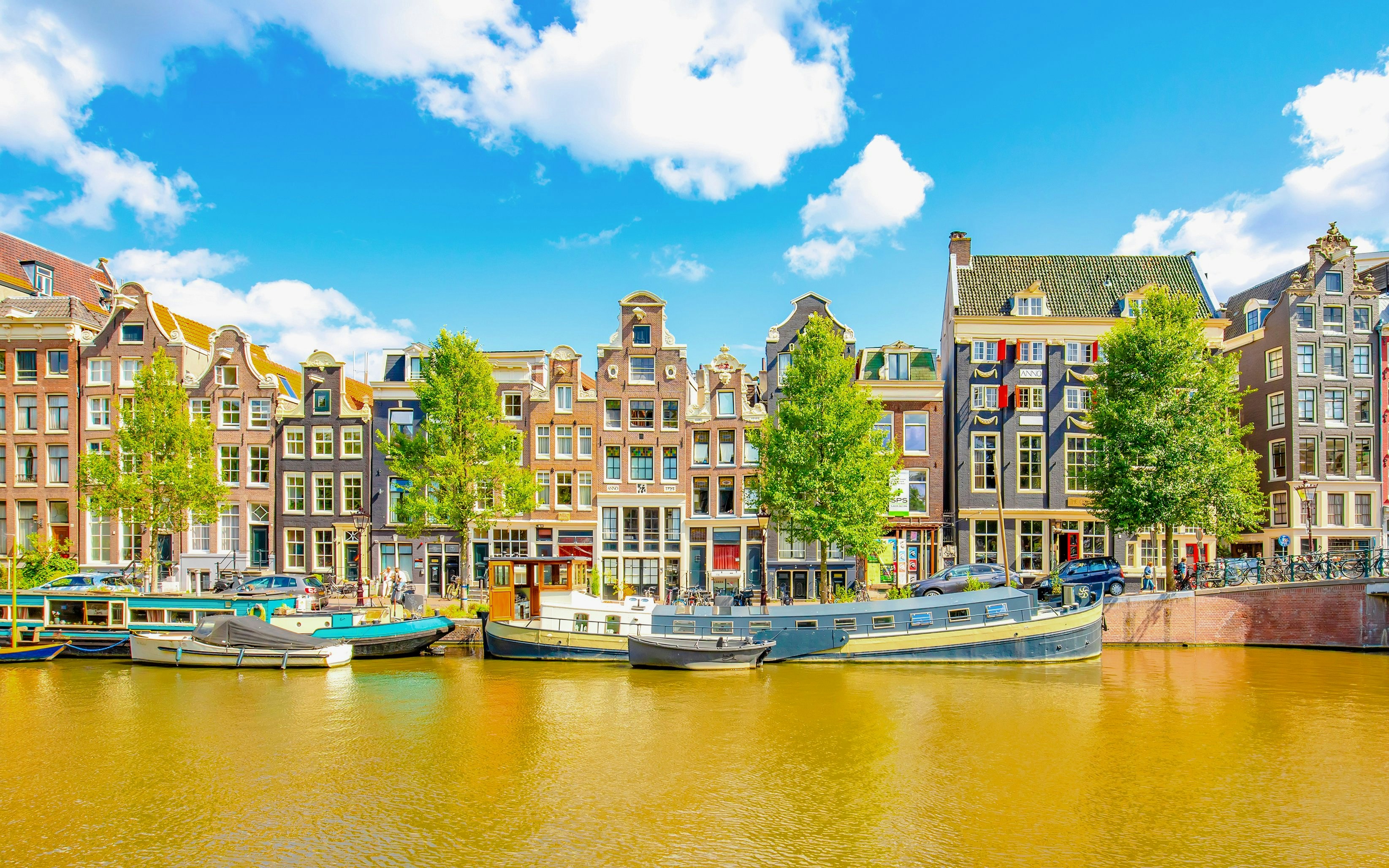 Amsterdam city skyline with colorful dancing houses along Singel canal, Netherlands.