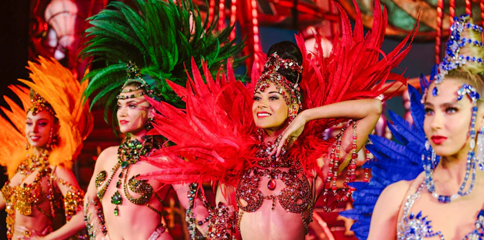 Performers in vibrant costumes at the Moulin Rouge Show, Paris.