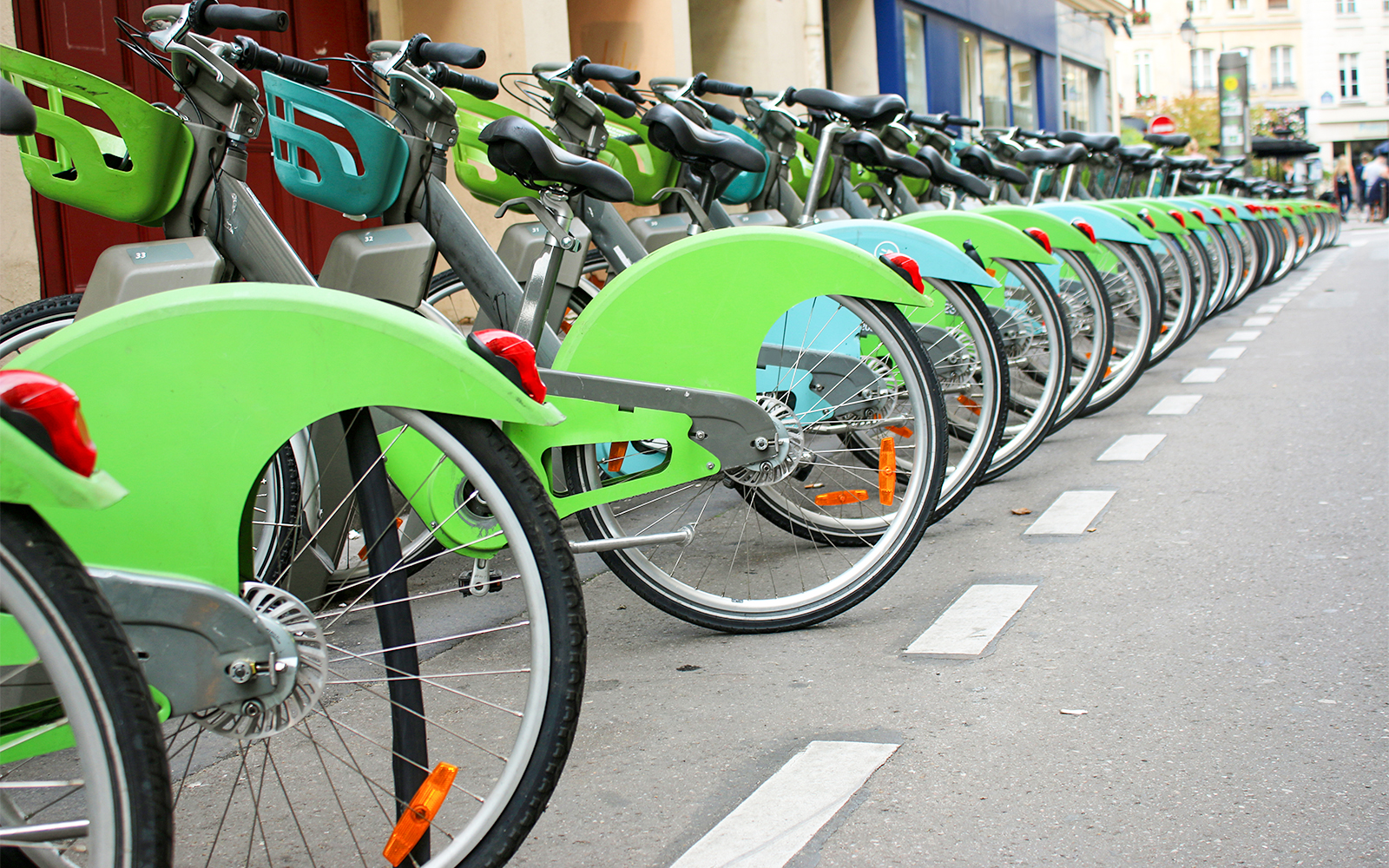 Cyclist riding a Velib bike near the Louvre Museum in Paris.