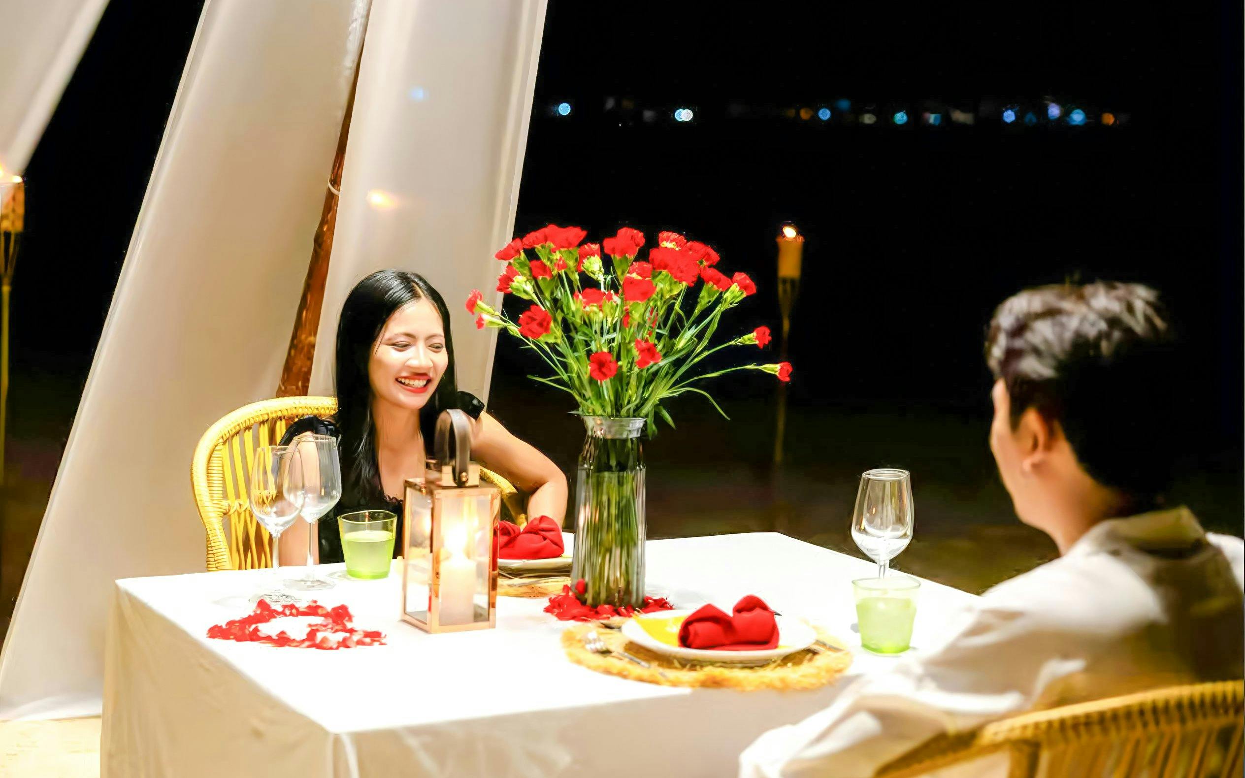Couple dining at candlelit table on Banana Beach Koh Hey.