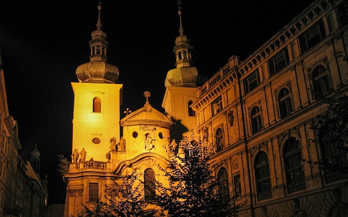 Historic Prague building illuminated at night, part of Ghosts and Legends tour.